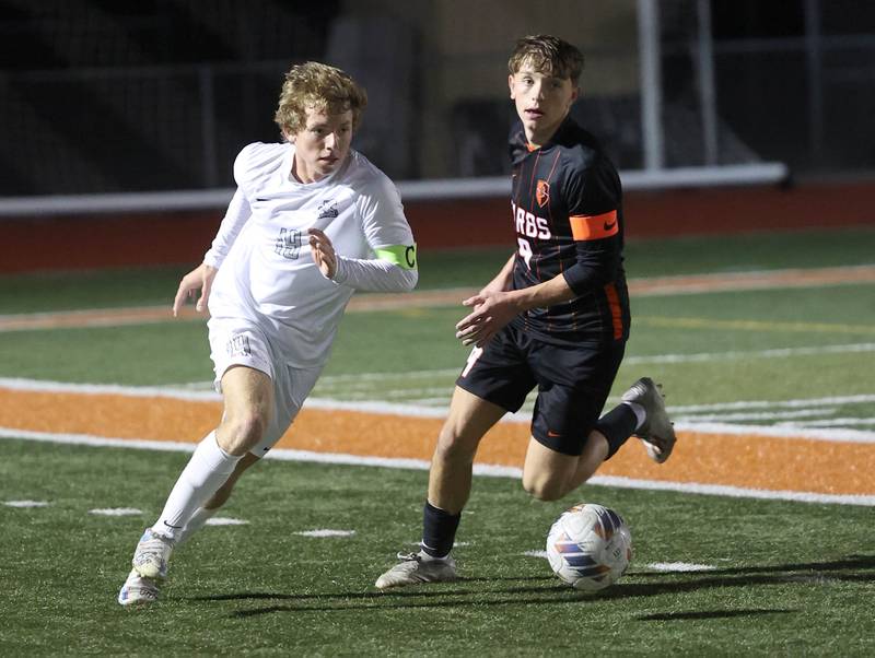 Kaneland's Michael Happ gets a step on DeKalb's Seth Hess as the go after the ball during their game Thursday, Oct. 12, 2023, at DeKalb High School.