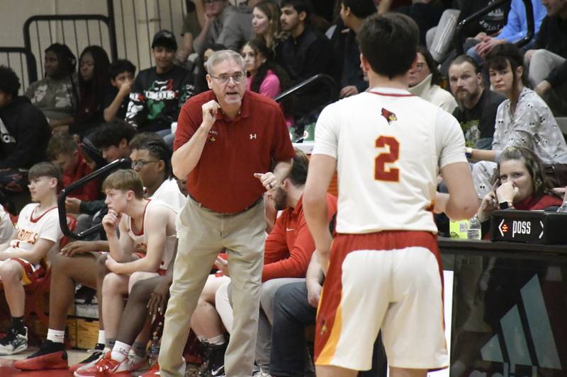 St. Anne head coach Rick Schoon gives advice to Matthew Langellier during St. Anne's 61-46 victory over Momence on Tuesday December 9, 2025.