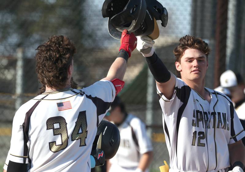 Sycamore's Kyle Prebil (right) is congratulated after homering by Davis Collie who would go back-to-back with a homer in his at bat during their game against Ottawa Friday, April 19, 2024, at the Sycamore Community Sports Complex.