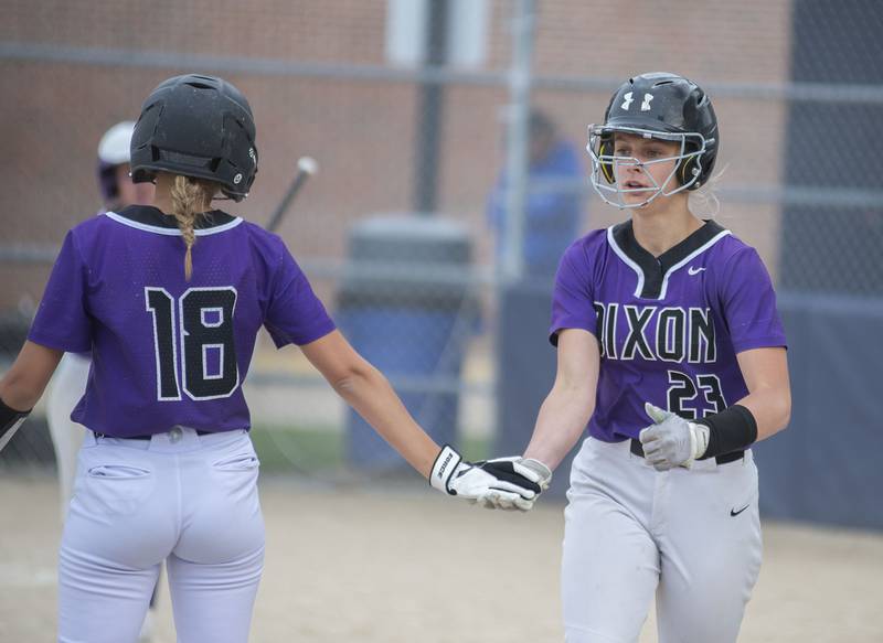 Dixon's Izzi McCommons (right) celebrates with teammate Olivia Mowery after scoring against Rochelle Tuesday, May 24, 2022.