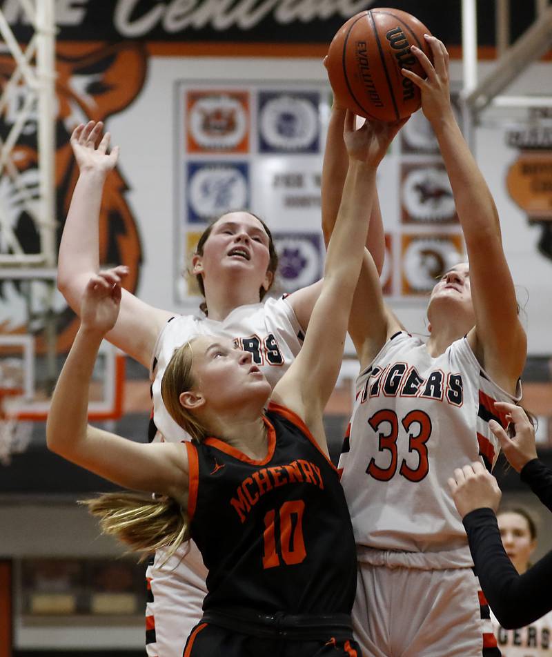 McHenry's Bethany Snyder, center, battles with Crystal Lake Central's Leah Spychala, left, and Kathryn Hamill, right, for a rebound during a Fox Valley Conference girls basketball game Tuesday, Nov.. 29, 2022, between Crystal Lake Central and McHenry at Crystal Lake Central High School.