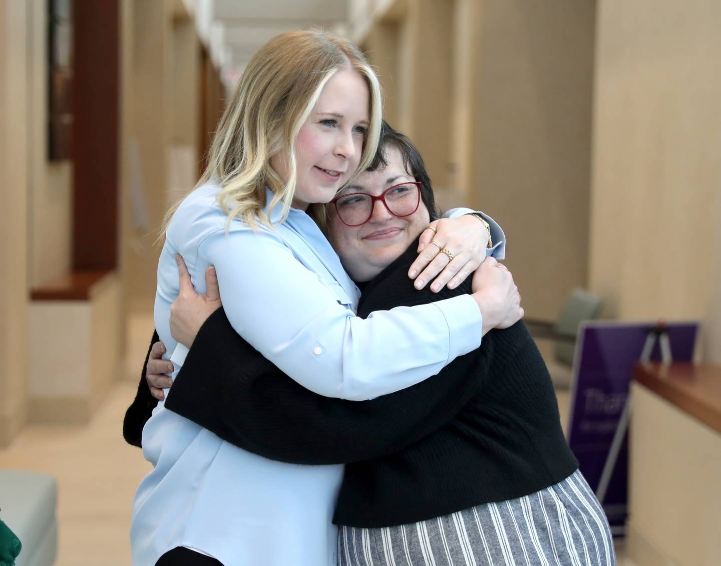 Christina Keasler of St. Charles (right) hugs Shannon Brown, an oncology social worker, on Thursday, May 1, 2025 at the Northwestern Medicine Cancer Center Delnor in Geneva. Keasler is the first recipient of a gift from the Mary DeRosa Foundation, a charity founded by Mary’s widower, Guy DeRosa, and his children to support others with cancer. Mary DeRosa of South Elgin died of metastatic triple-negative breast cancer in 2022.