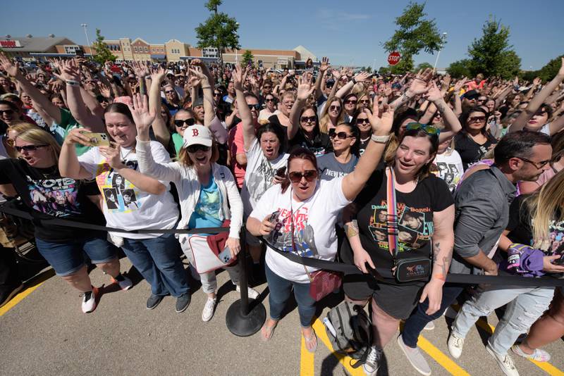 New Kids on the Block fans fill the parking lot outside the Wahlburgers in St. Charles for the Wahlk of Fame Ceremony on Saturday, June 18, 2022.