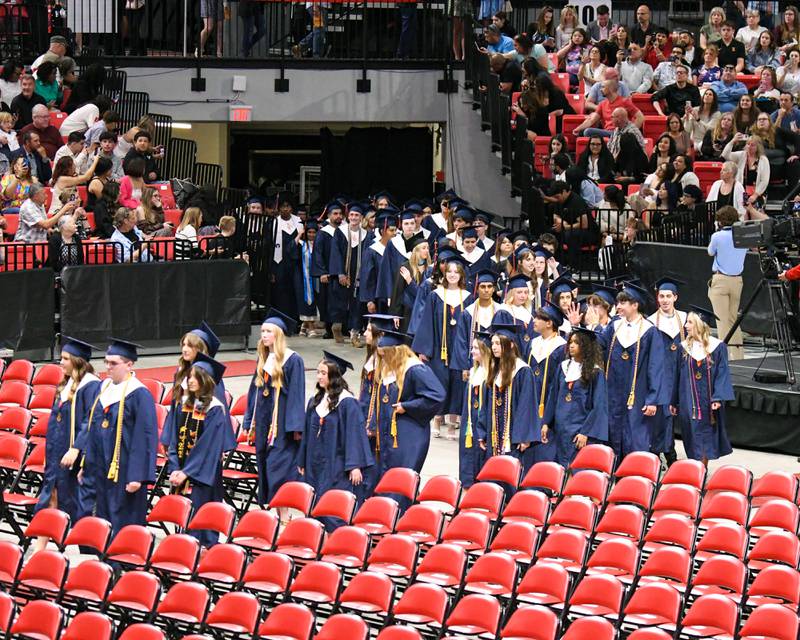 Oswego High School graduates make their way in during the processional portion of the graduation ceremony on Saturday May 17, 2025, held at the Convocation Center in DeKalb.