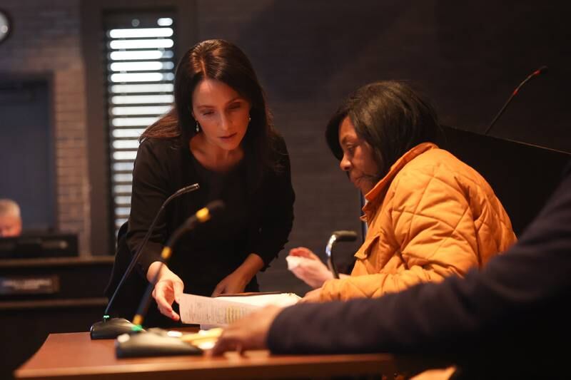 Corperation Counsel Sabrina Spano goes over paperwork with Jeanetta Gordon at a hearing on the validity of City Council candidate Michael Carruthers’ nominating petitions at the Joliet City Electoral Board meeting on January 4th.