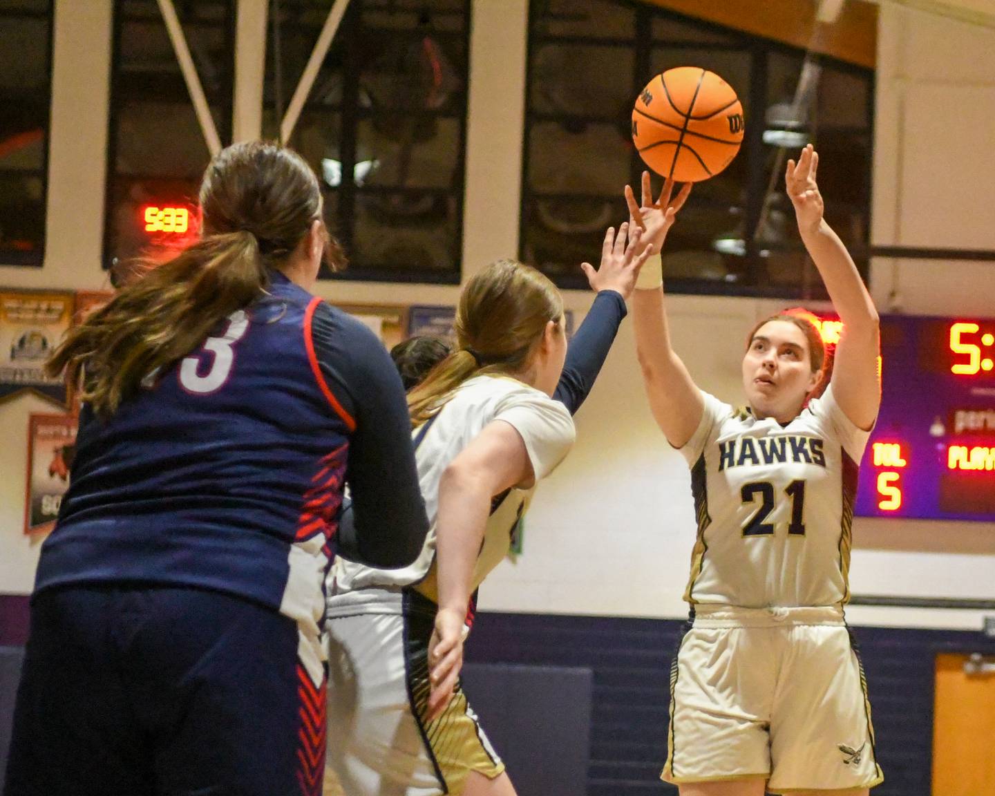 Hiawatha's Brielle Molloy (21) takes a shot during the game on Monday Dec. 22, 2025, while taking on Our Lady of The Sacred Heart, held at Hiawatha High School.