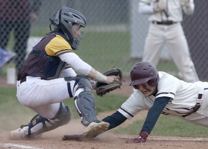 Jacobs’s Grant Helbig tags out Prairie Ridge's Jimmy Stone as he tries to steal home during a Fox Valley Conference baseball game Friday, April 29, 2022, between Prairie Ridge and Jacobs at Prairie Ridge High School.