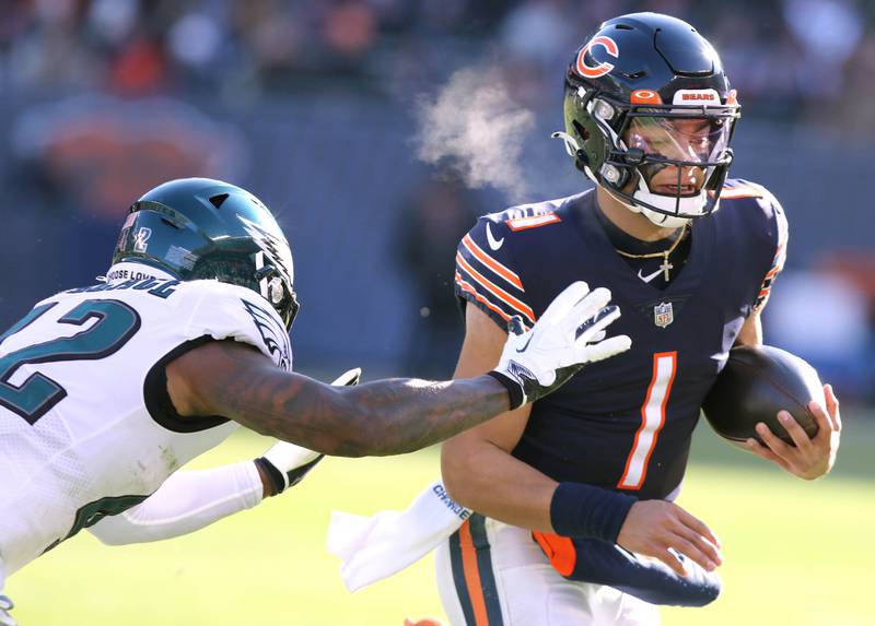 Chicago Bears quarterback Justin Fields gets outside of Philadelphia Eagles safety K'Von Wallace during their game Sunday, Dec. 18, 2022, at Soldier Field in Chicago.