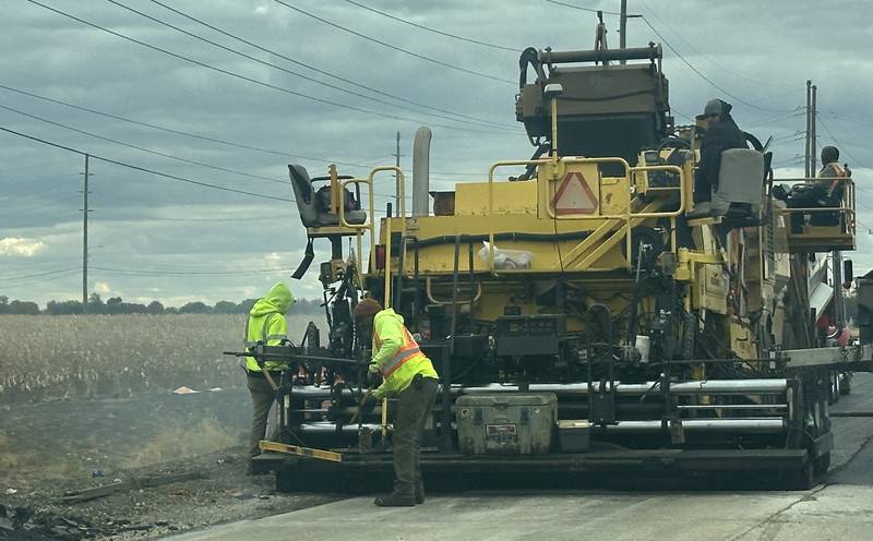Crews from Advanced Asphalt pave the final coat of asphalt on Plank Road on Tuesday, Oct. 21, 2025 in Peru. The first of three phases of Plank Road construction have been compleated The temporary stoplights have been removed from the construction zone. The project involved a new turn lane, wider lanes in both directions, curb and gutter, and addition of a recreation trail. Future plans are to reconstruct the road all the way to Interstate 80.