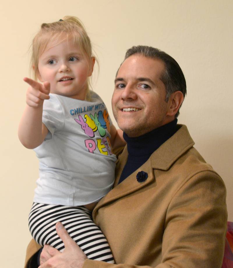 MaryAnna Kaleta of Downers Grove and her dad Mike wait in line to see the Easter Bunny during the Downers Grove Bunny Hop Egg Hunt Friday, March 22, 2024.