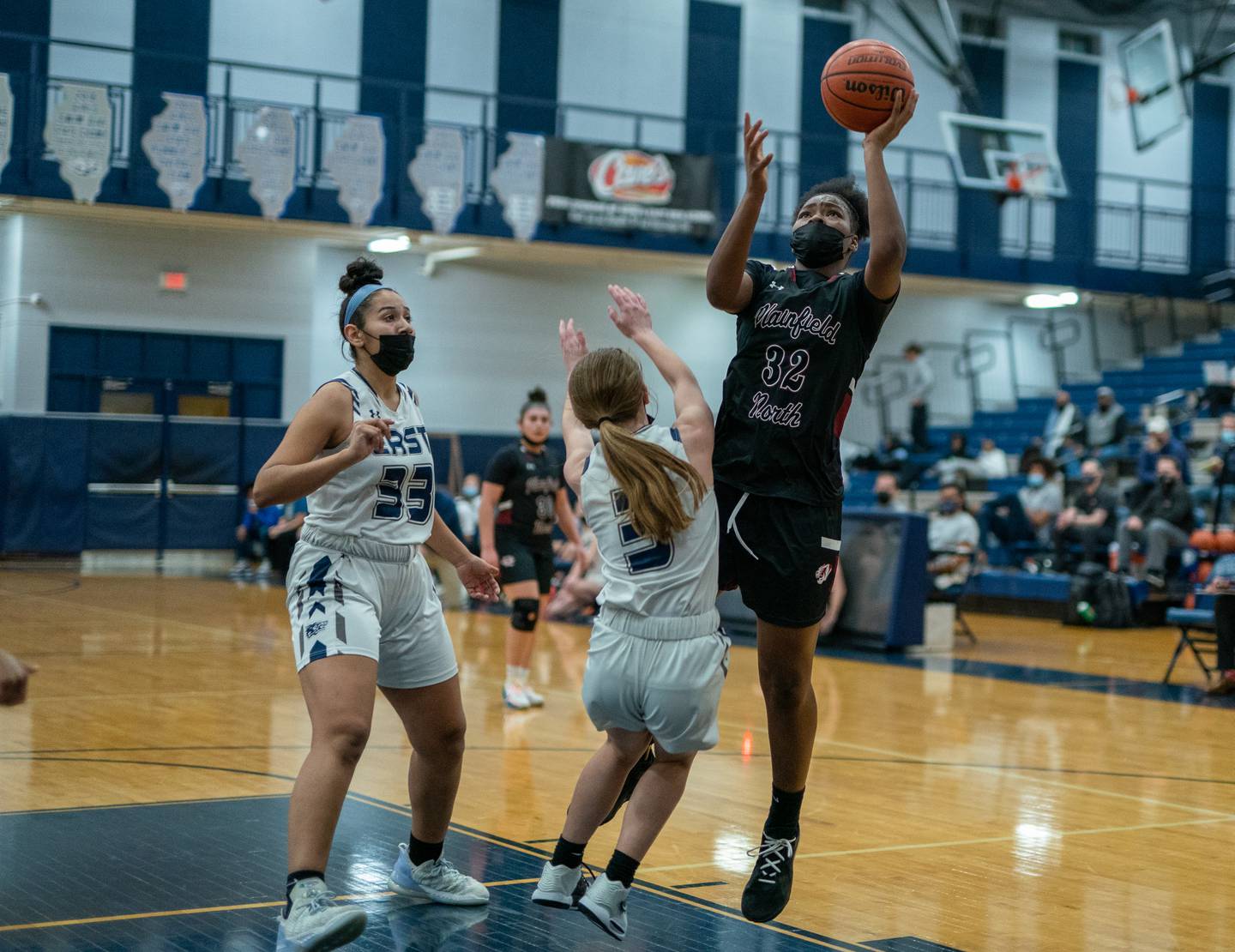 Plainfield North's Jalyn Patterson (32) shoots the ball in the post over Oswego East's Maggie Lewandowski (3) during a basketball game at Oswego East High School on Tuesday, Jan 18, 2022.