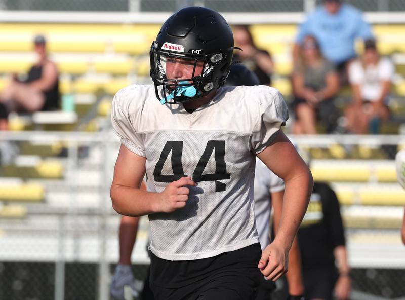 Sycamore’s Cooper Bode runs off the field after a scrimmage with Lena-Winslow Thursday, July 24, 2025, during a joint practice with Byron, Lena-Winslow and Sycamore at Sycamore High School.