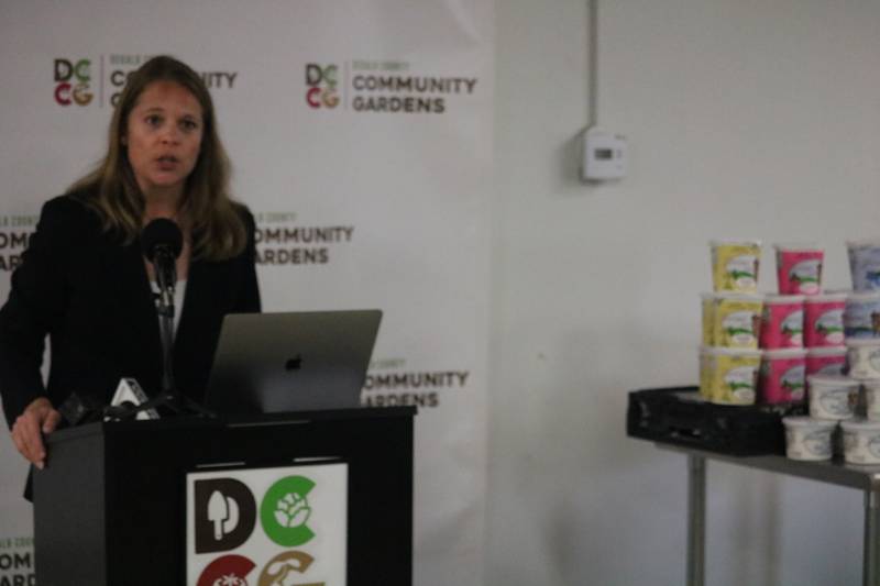 DeKalb County Community Gardens Executive Director Heather Edwards speaks Aug. 19, 2024 during a press conference held at the agency's main warehouse building in DeKalb.