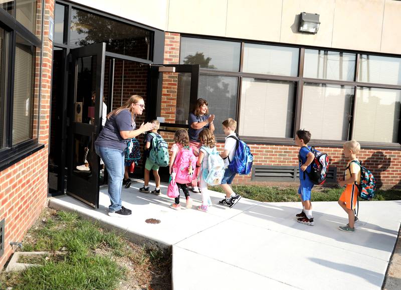 Students enter the school on the first day Thursday, Aug. 22, 2024 at Harrison Street Elementary School in Geneva.