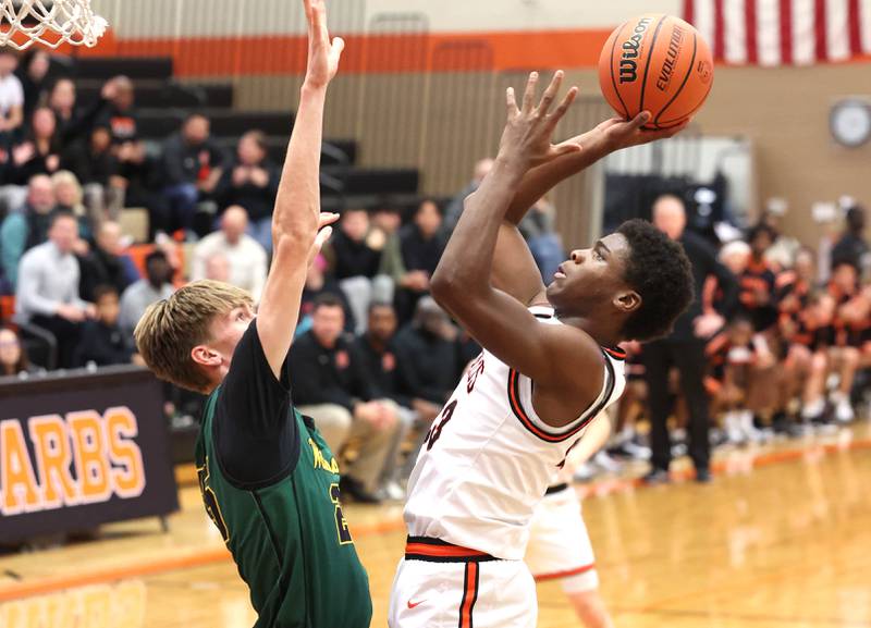 DeKalb’s Davon Grant shoots over Waubonsie Valley’s Cade Valek during their game Friday, Dec. 15, 2023, at DeKalb High School.