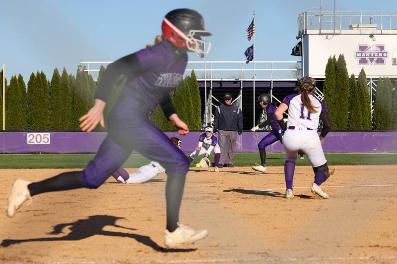 Manteno's Aubrie Goudreau fields a grounder as Wilmington runners advance during the Panthers' 9-7 victory over the Wildcats on Tuesday, April 8, 2025.