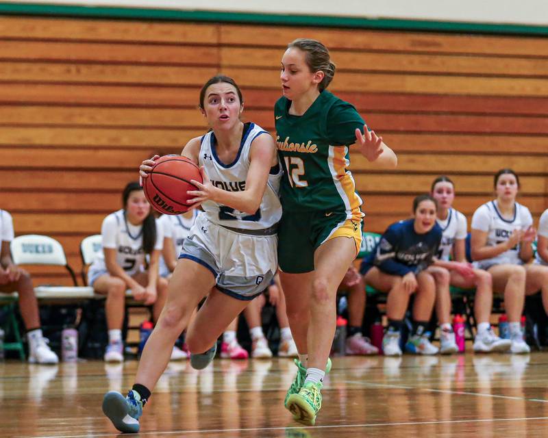 Oswego East's Brooke White (23) drives baseline at the York Thanksgiving Tournament. Nov 13, 2023.