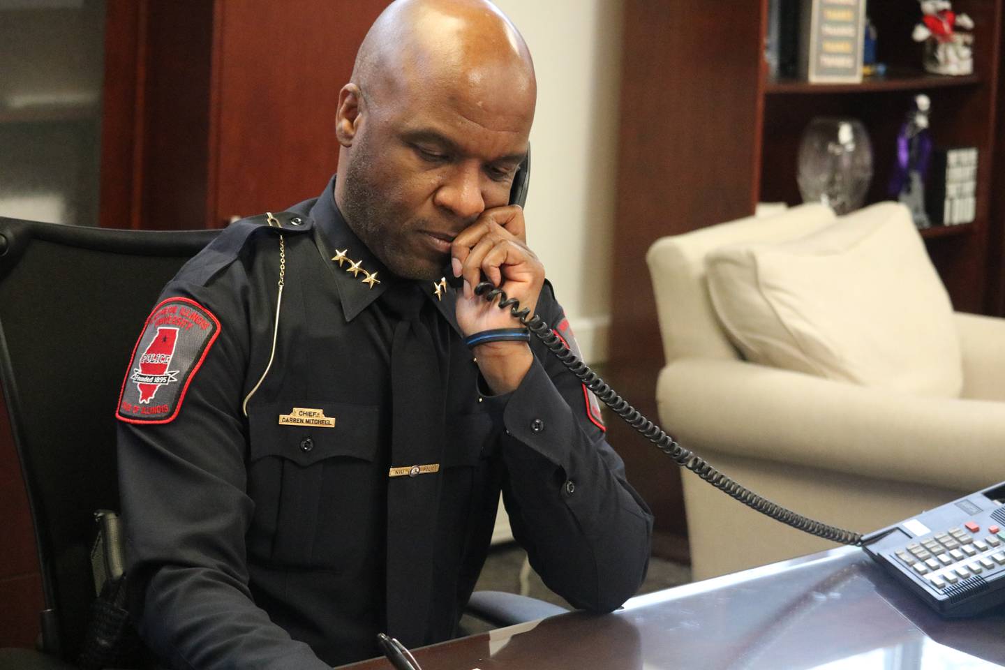 NIU Chief of Police Darren Mitchell talks on the phone Thursday, Feb. 9, 2023 in his office at the NIU Department of Police and Public Safety in DeKalb.