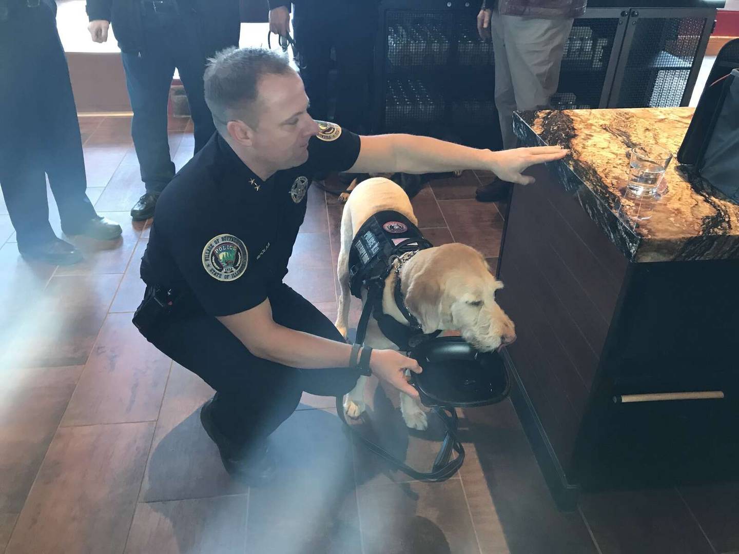 Buffalo Grove Police Deputy Chief Brian Spolar with therapy dog Grady at Tuesday's opening of the Lazy Dog restaurant in Buffalo Grove.