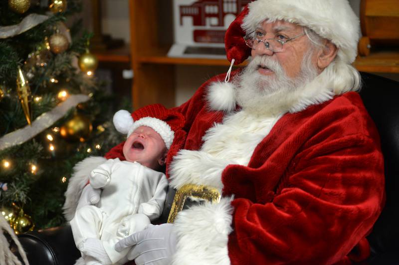 Luella Garrey, 1 month old, wasn't too sure about telling Santa what she wanted for Christmas as she and her mom, Maddison, visited with him Saturday, Nov. 30, 2024, at the Oregon United Methodist Church's Kid's Christmas Carnival during Oregon's Candlelight Walk.