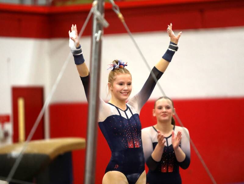Oswego Co-op’s Sam Phillip competes on the uneven bars during the Hinsdale Central Sectional on Monday, Feb. 10, 2025 in Hinsdale.
