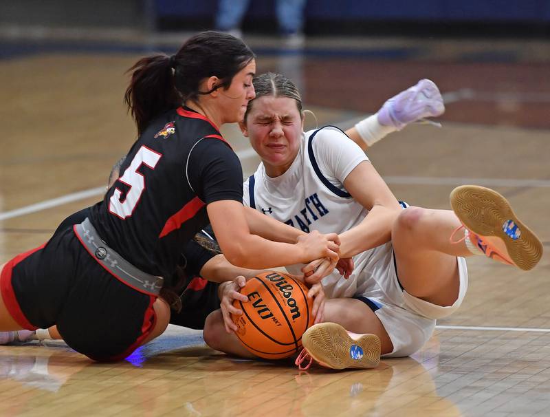 Benet’s Ava Thomas (5) and Nazareth’s Stella Sakalas tangle for a loose ball during a game on December 13, 2025 at Nazareth Academy in LaGrange Park.