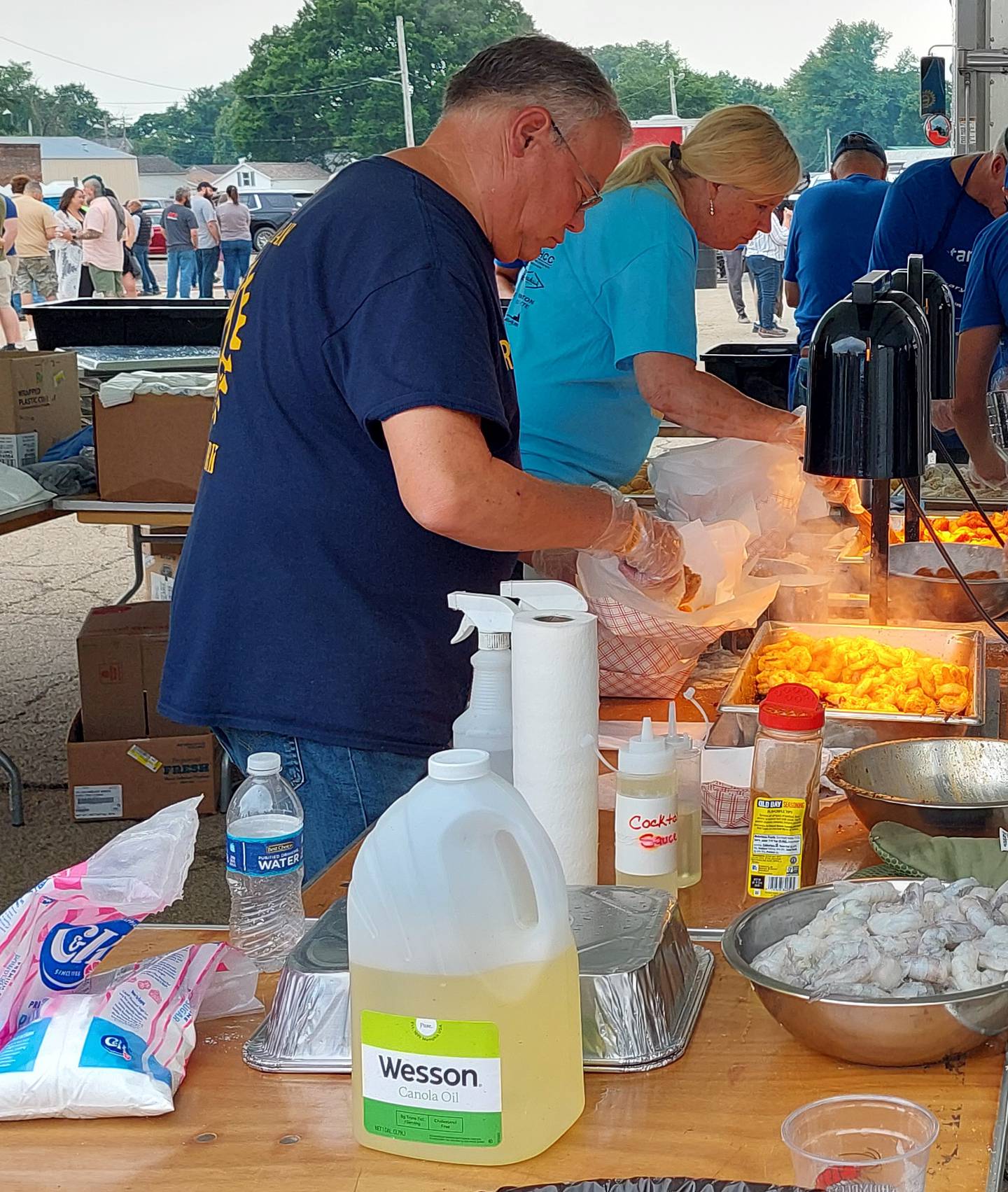 Volunteers for the Princeton Rotary club prepare grilled and fried shrimp baskets for customers Saturday, June 1, 2023, at the ShrimpFest and Brew Hullabaloo at Rotary Park in Princeton.