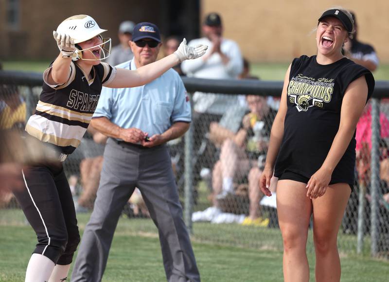Sycamore's Ema Durst and first base coach Mia Richards have a laugh after Durst gets on base by being hit in the helmet with a pitch during their Class 3A supersectional game Monday, June 3, 2024, against Antioch at Kaneland High School in Maple Park.