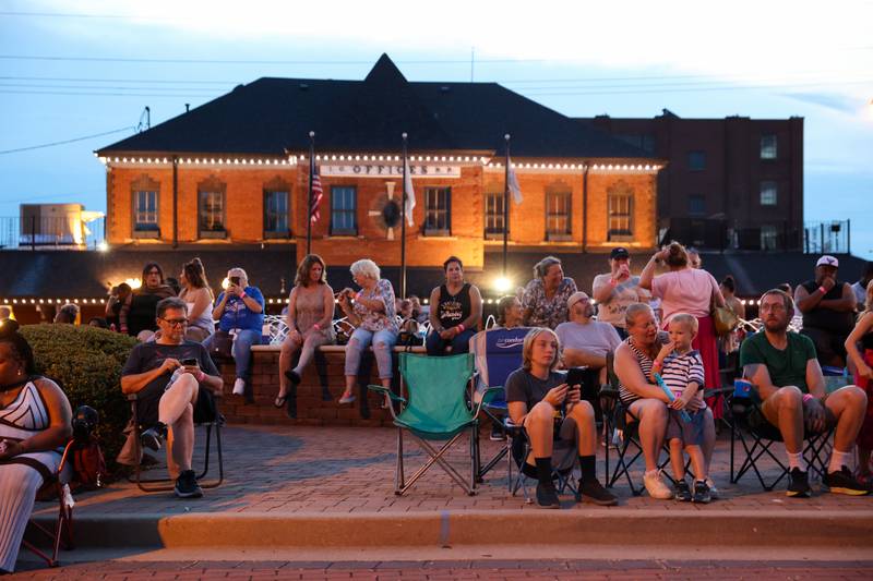 Attendees gather near the fountain to listen to a performance on the Merchant Street Stage during Merchant Street MusicFest on Friday, July 25, 2025.