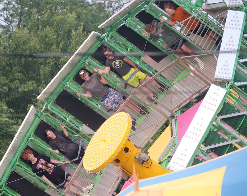 People ride the Gravitron at the Lions Club Carnival on Thursday, June 15, 2023 in Ottawa