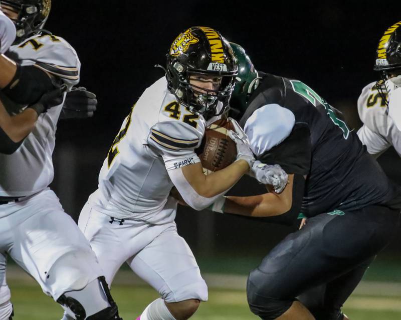 Joliet West's Gavin Garcia (42) runs up the middle during football game between Joliet West at Plainfield Central.   Oct 20, 2023.