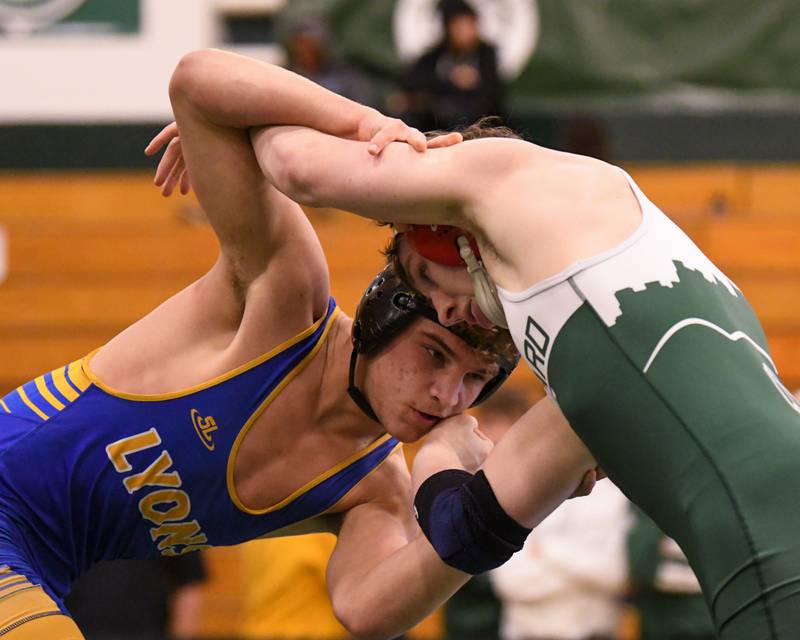 Gunnar Garelli of Lyons Township, left, goes head to head with Glenbard West wrestler Collin Carrigan during the regional title match on Saturday Feb. 3, 2024 held at Glenbard West High School where Gunnar took the win.