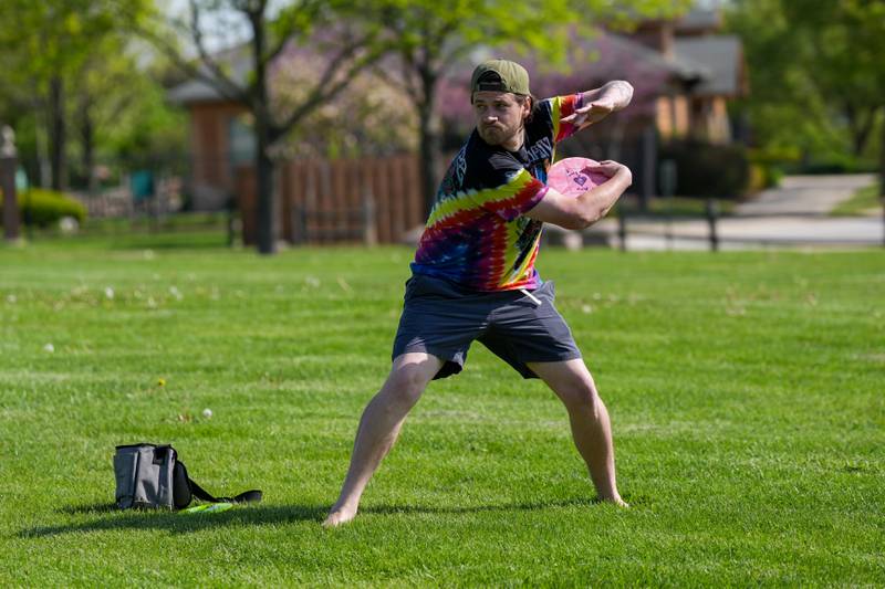 A player throws a disc  to advance his position during the Glen Ellyn Park District Ace Race disc golf event at Maryknoll Park in Glen Ellyn, IL on Saturday May 10th, 2025.  The Ace Race is just one of many events the Glen Ellyn Park District holds throughout the year.