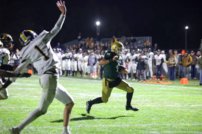Bishop McNamara quarterback Karter Krutsinger runs in a touchdown during Bishop McNamara's 38-14 victory over Herscher in the IHSA Class 3A first round playoff game on Friday, Oct. 31, 2025.