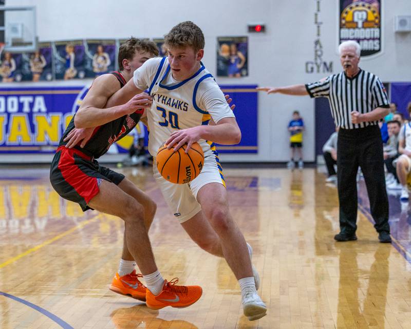 Jayce Schmitt (30) of Johnsburg drives ball down sideline as Aurora Christian's Preston Morel (3) guards at hip during the Class 2A Boys Sectional Basketball tournament game on Wednesday, March 4, 2026 at Mendota High School.