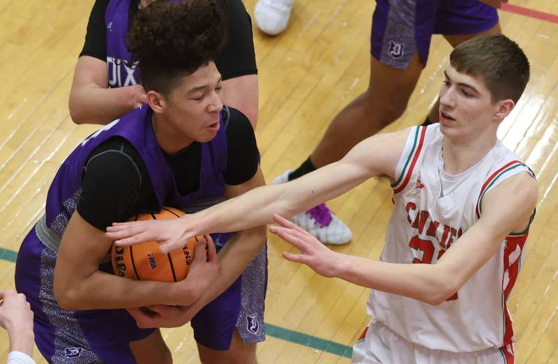 Dixon's Armahn McGowan secures a rebound over L-P's Gavin Stokes during the Class 3A Regional semifinal game on Wednesday, Feb. 25, 2026 in Sellett Gymnasium at L-P High School.